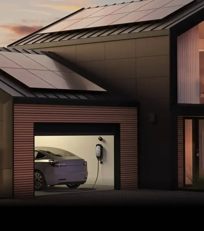 A modern house with solar panels on the roof, a garage with an electric car inside, and a solar charging station mounted on the garage wall.