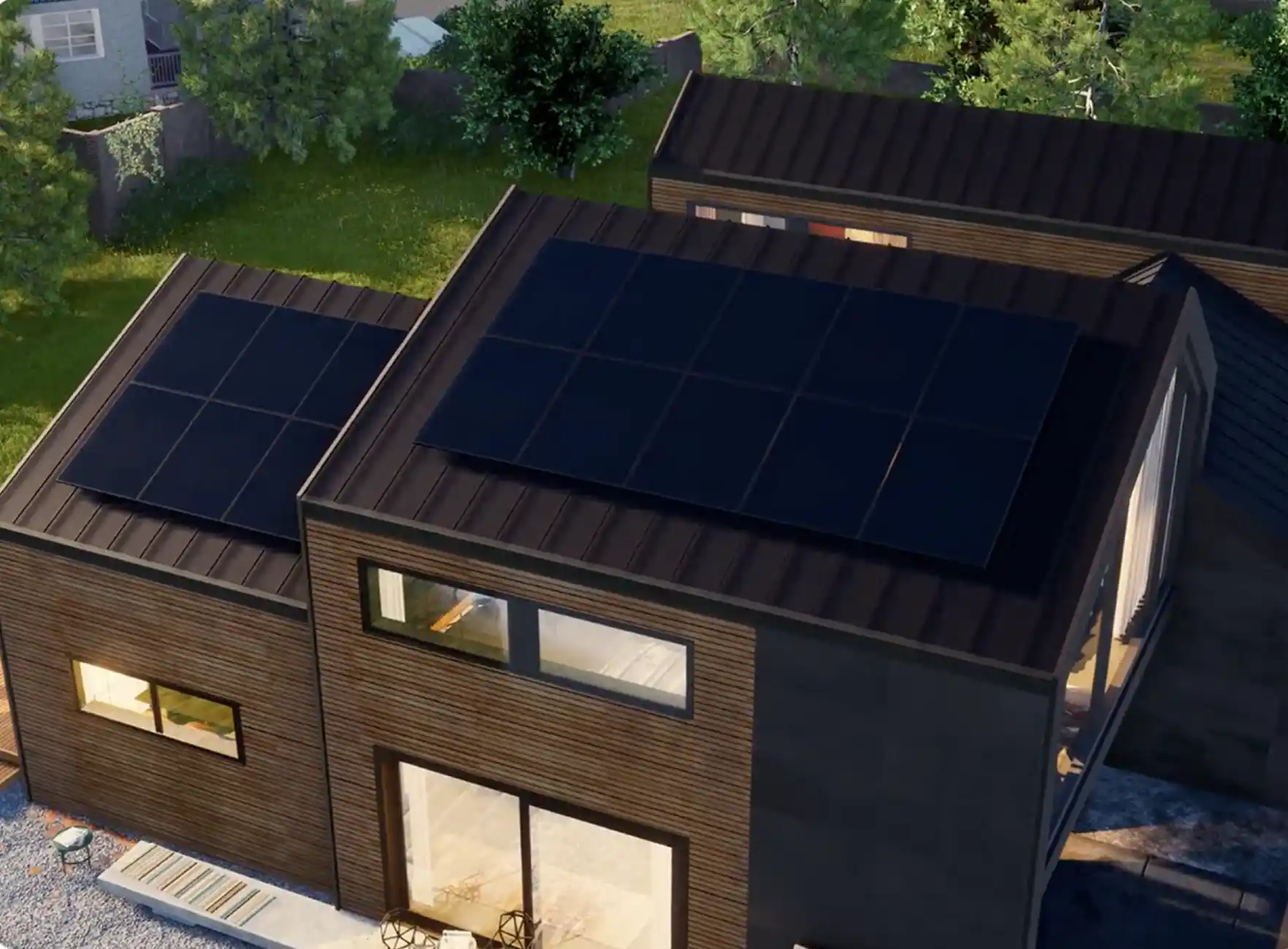 A modern house with flat roofs boasting solar and smart electrical panels. The building features large windows, surrounded by green trees, with a wooden exterior finish. A small outdoor area is visible in the lower part of the image.